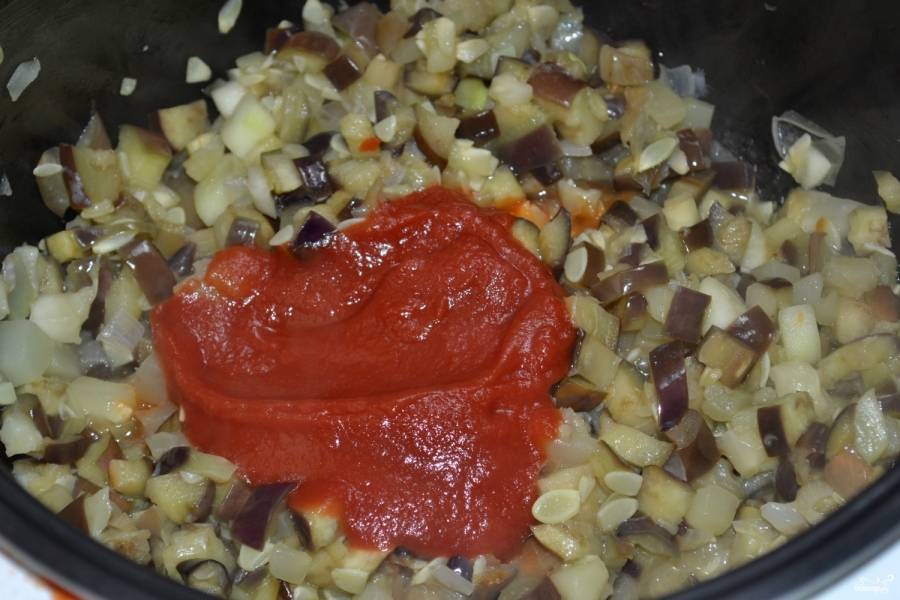 В сотейник влейте подсолнечное масло и хорошо разогрейте. Сначала поджарьте лук, чтоб он стал прозрачным. Потом добавьте порезанные кабачки, баклажаны хорошенько отожмите от выделившегося сока и тоже отправьте тушиться. Готовьте икру под закрытой крышкой на медленном огне примерно час, периодически помешивая. Потом добавьте томатную пасту, хорошо размешайте и томите еще 30 минут. За 5 минут до окончания варки добавьте пропущенный через пресс чеснок, молотый черный перец и посолите.