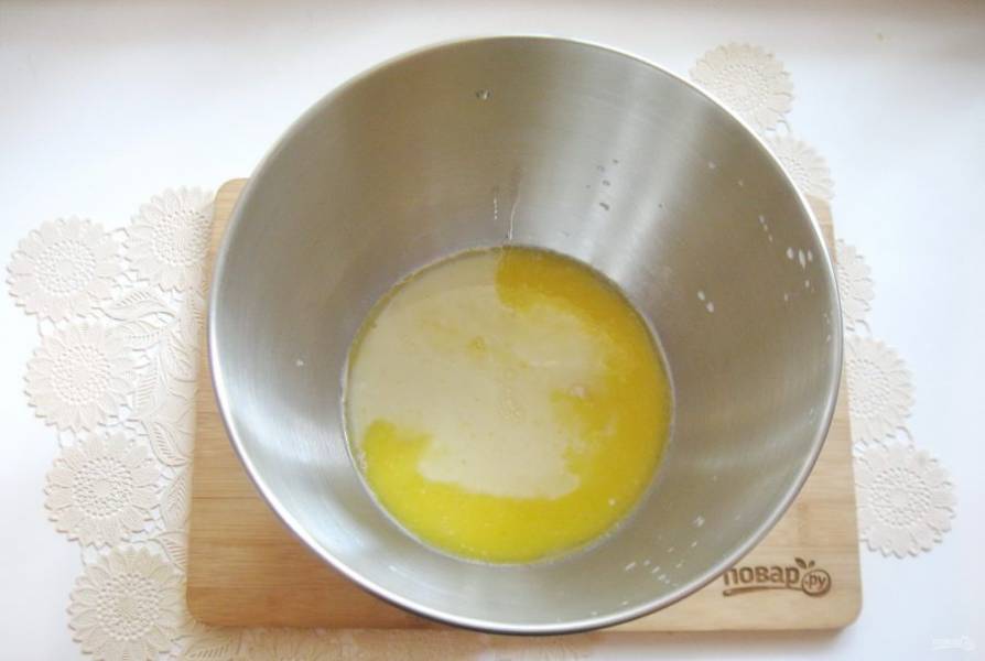 Растопите сливочное масло, немного охладите и тоже добавьте в миску.