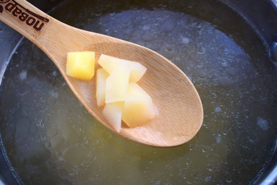 4. Картофель нарежьте кусочками, отправьте в кипящий бульон.
