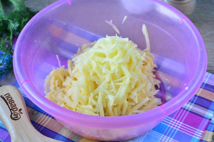 Картофель натрите на терке и переложите в миску.