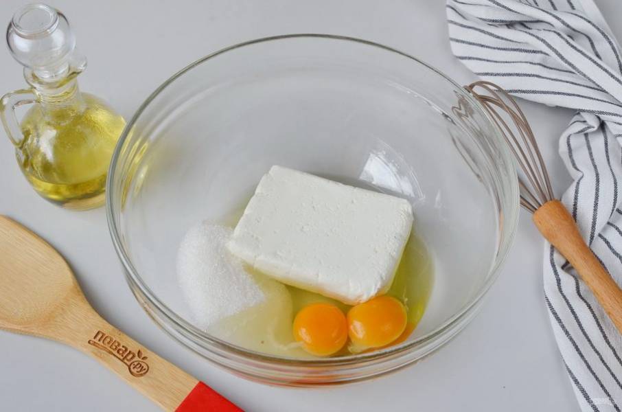 В большую миску выложите яйца, сахар и творог. Венчиком разотрите все ингредиенты до однородности. Если хотите, чтобы крупинок творога не было совсем, тогда пробейте массу погружным блендером.
