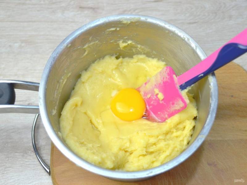 По одному вливайте яйца в тесто, интенсивно вмешивая каждое яйцо. Каждое последующее яйцо вмешивайте тогда, когда полностью вмешаете предыдущее яйцо.