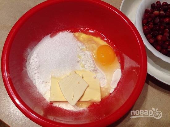 Просеиваем в миску муку, смешиваем ее с разрыхлителем. Добавляем мягкое сливочное масло, сахар обычный и ванильный, яйцо и сметану.