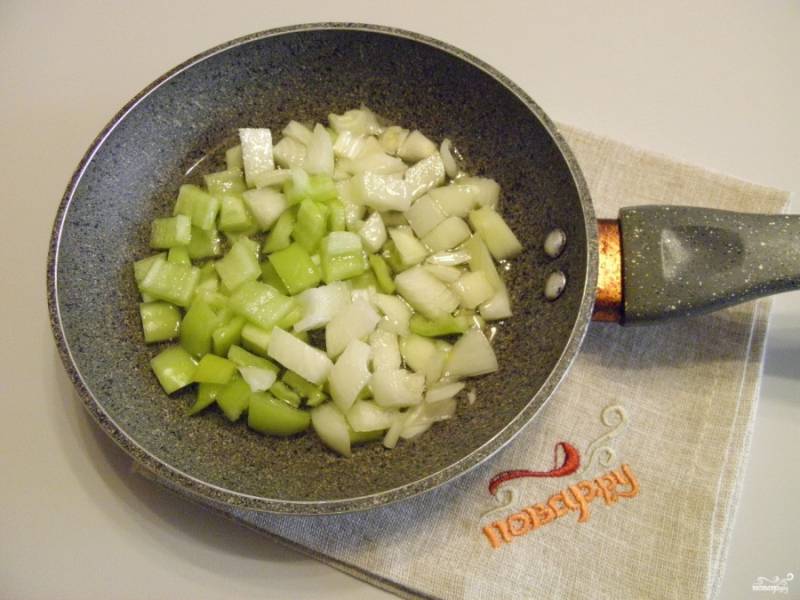 Обжарьте на подсолнечном масле со щепоткой соли лук и перец до полуготовности.