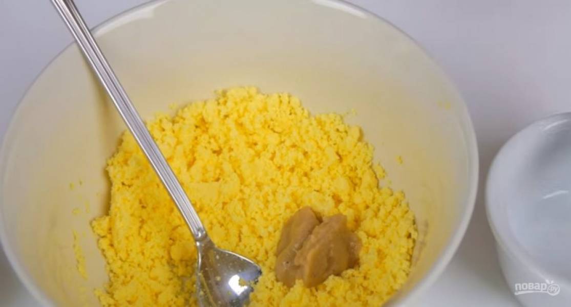 4. Отварные желтки разотрите, добавьте горчицу, соль и немного оливкового масла. Размешайте и продолжайте добавлять масло небольшими порциями, пока масса не станет густым соусом. Добавьте кетчуп и перемешайте.