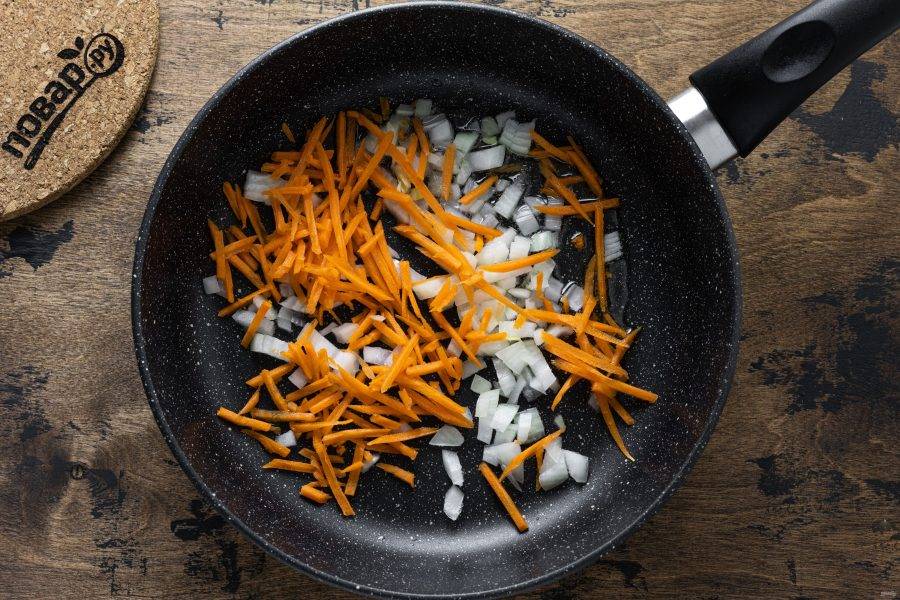Нарежьте кубиками репчатый лук, морковь натрите на терке. Обжарьте овощи на среднем огне 2-3 минуты до золотистого цвета.
