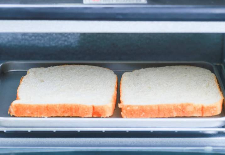 Прежде всего подготовьте белый хлеб. Его нужно подсушить до образования хрустящей корочки. Это можно делать в тостере, духовке или на обычной сковороде без добавления масла.