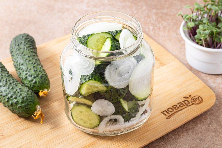 Заполните банку огурцами и репчатым луком.