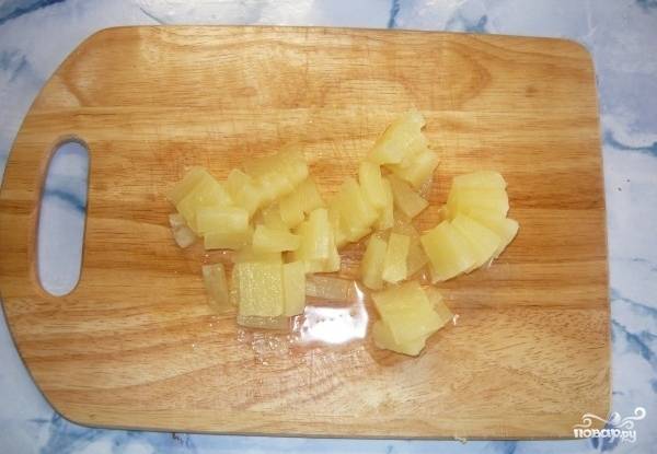 Кусочки ананасов извлекаем из банки и так же нарезаем на кубики.