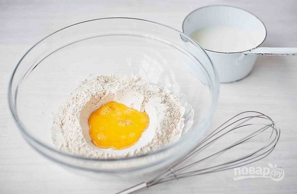 1. В глубокую мисочку просейте муку, добавьте дрожжи, соль и вбейте яйцо. Влейте теплое молоко. 