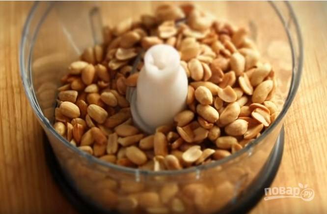 4. Жареные орешки заложите в чашу блендера и измельчите. Смешайте половину  ореховой крошки с тестом.