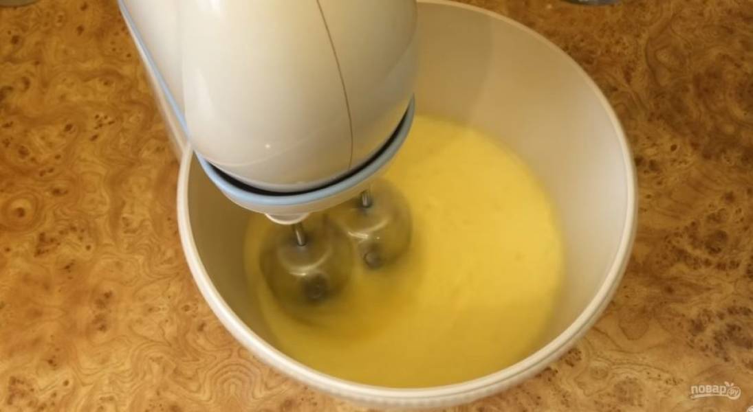 1. Приготовьте бисквит: миксером взбейте яйца. Не переставая взбивать, добавьте порциями сахар и взбейте до густой белой пены. Добавьте сливочное масло комнатной температуры. 