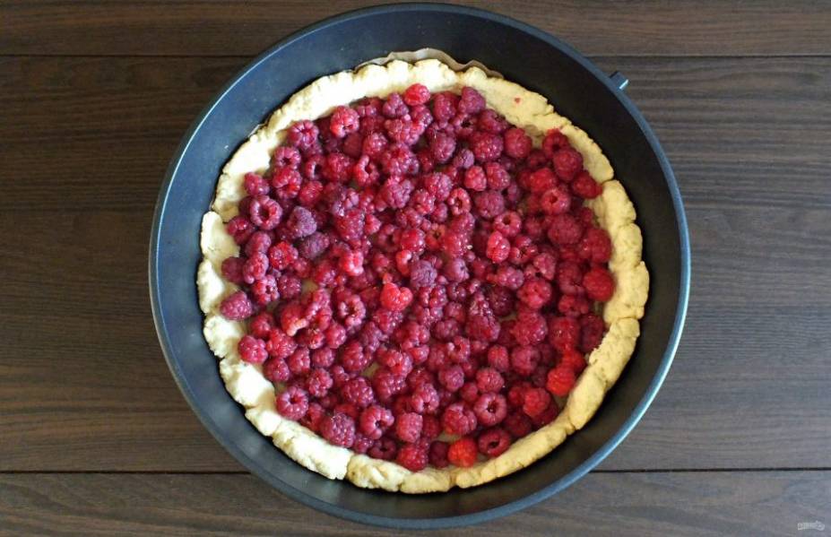 В подпеченную основу пирога выложите чистые ягоды малины. Разровняйте.