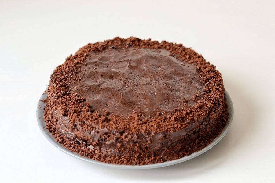 Покройте торт первым слоем ганаша, уберите в холодильник на 10 минут. Затем вторым. Края торта украсьте высушенной крошкой.
