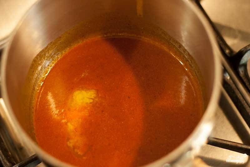 5. Теперь можно заняться соусом. Для начала отправьте в сотейник томатный соус (лучше использовать в рецепт приготовления крылышек в сметанно-чесночном соусе острый соус или добавить в натуральный томат острый перец). Добавьте немного сливочного масла. Посолите по вкусу и доведите до кипения. 