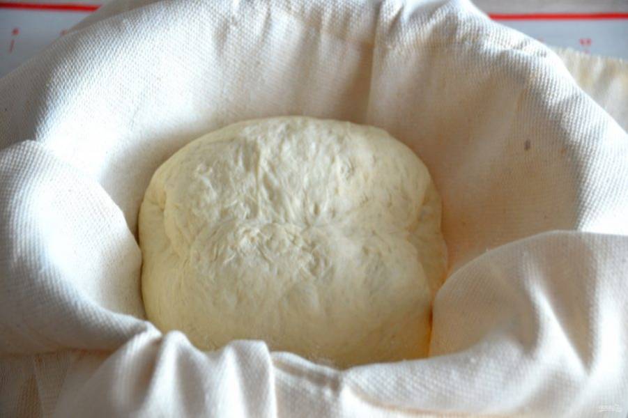 Выложите хлеб в расстоечную корзину, если такой корзины нет, подойдет любая, подходящая по размеру емкость, которую необходимо застелить тканью, хорошо "затертую" мукой. Выложите хлеб швом верх, прикройте краями ткани. Дайте расстойку 1 час.