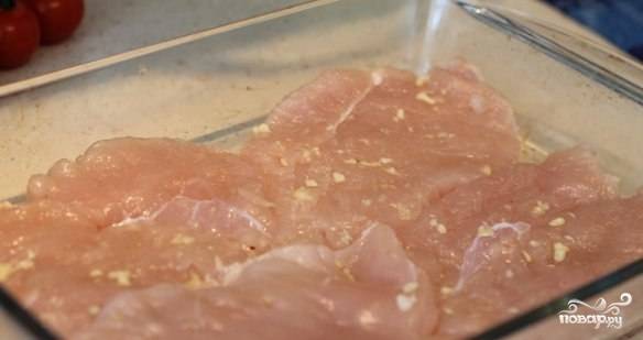 Куриное филе моем, разрезаем на стейки (500 грамм - на 3-4 стейка). Слегка отбиваем, натираем выдавленным чесноком, солью и перцем, после чего выкладываем в форму для запекания.