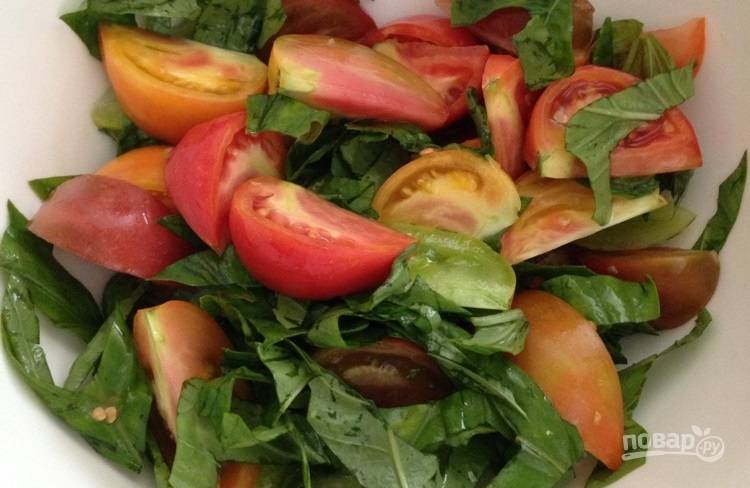 1.	Вымойте томаты разрежьте их на 4 дольки или больше, в зависимости от размера. Нарежьте крупно листья базилика, смешайте томаты и зелень в миске.