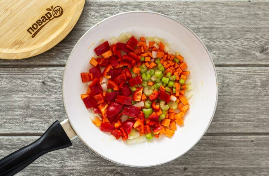 Нарежьте репчатый лук, морковь, сельдерей и сладкий перец кубиками. Обжарьте овощи в сковороде с небольшим количеством масла примерно 5-7 минут.