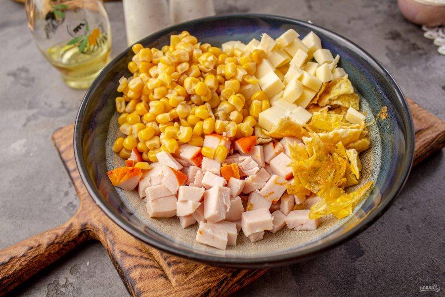 В салатник добавьте консервированную кукурузу без жидкости. 