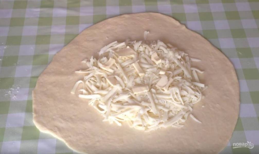 В центр каждой лепешки выкладываем сыр и буквально чуть-чуть масла (оно придаст начинке сочность).