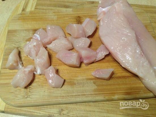 Блюдо готовилось на 1 порцию, поэтому берем треть филе куриной грудки. Нарезаем на небольшие кусочки.