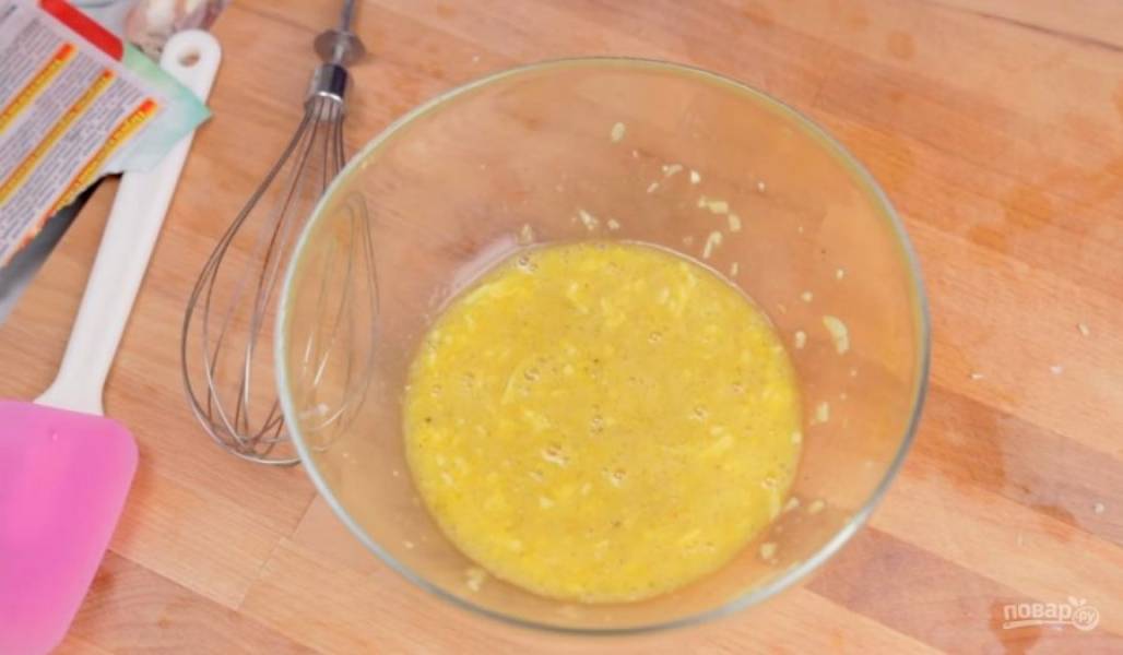 1. Для начала приготовьте яичную смесь. Для этого два яйца и один желток хорошо взбейте венчиком с тертым сыром, перцем и солью. Добавьте мелко нарезанный чеснок. 