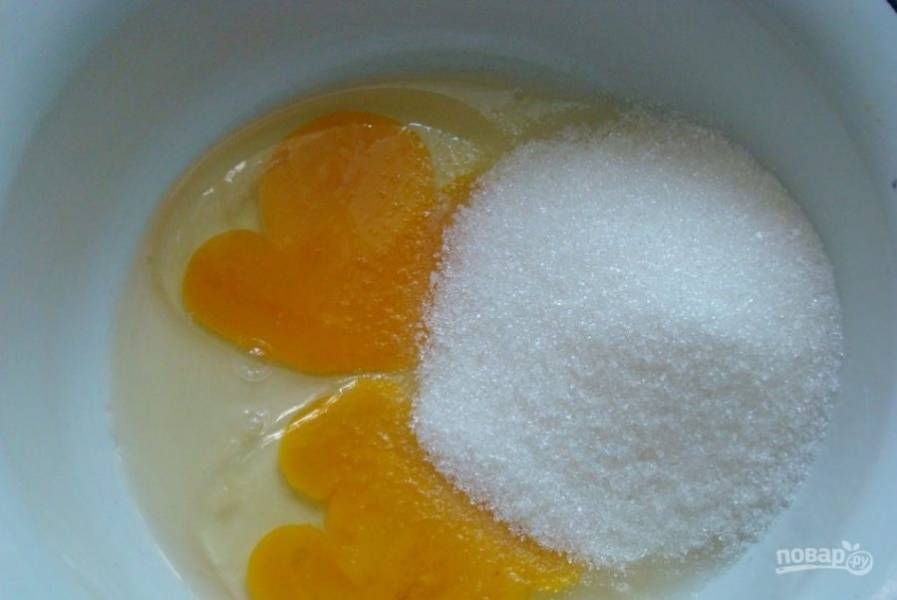 2.	В миску к куриным желткам добавьте стакан сахарного песка, взбивайте на средних оборотах (если работаете с миксером) или ручным венчиком.