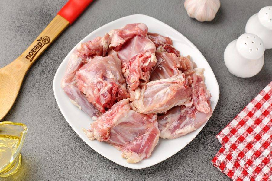 Мясо кролика промойте, обсушите и нарежьте порционными кусочками.