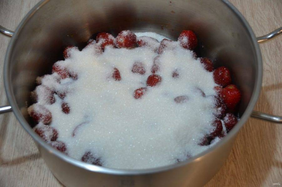 Очистите клубнику от плодоножки. Выложите ягоды в кастрюлю с толстым дном, засыпьте сахаром, оставьте на 2-3 часа, чтобы клубника дала сок.