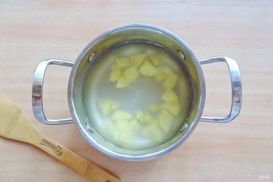 В кастрюлю налейте бульон и выложите нарезанный картофель.