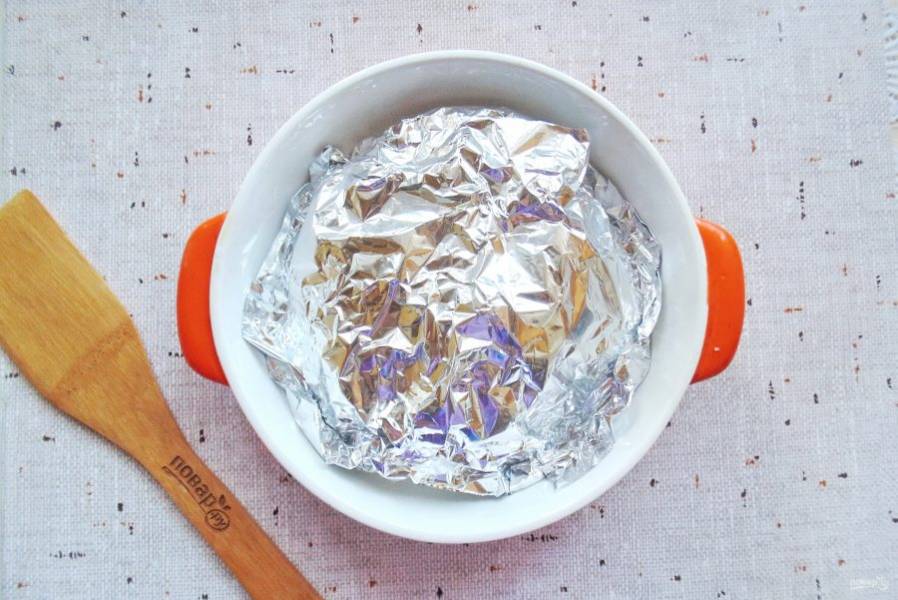 Заверните картофель в фольгу и выложите в форму для запекания.