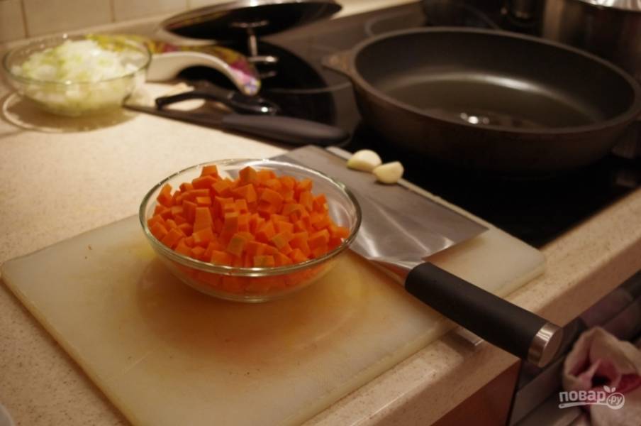 1. В нашей семье мясо, тушенное с грибами, — это традиционное блюдо. Готовим мы его всегда на основе говядины и грибов. Для начала чистим и шинкуем морковь.