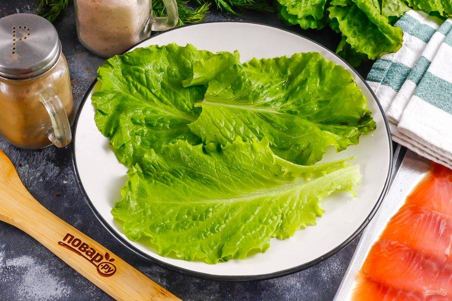 Промойте салатные листья и выложите их на тарелку, блюдо.