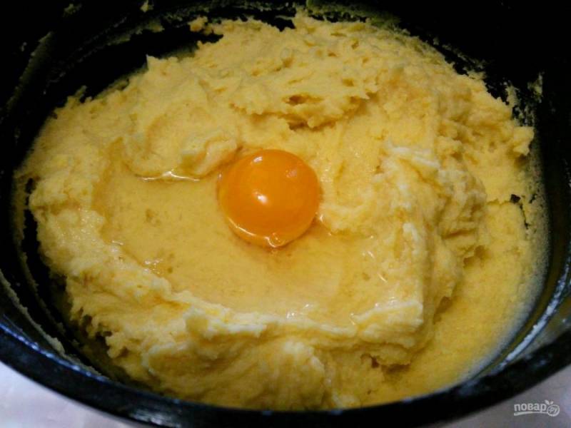 Дайте заваренной кукурузной массе остыть до тёплого состояния и введите яйца по одному. Размешайте тесто до однородности.