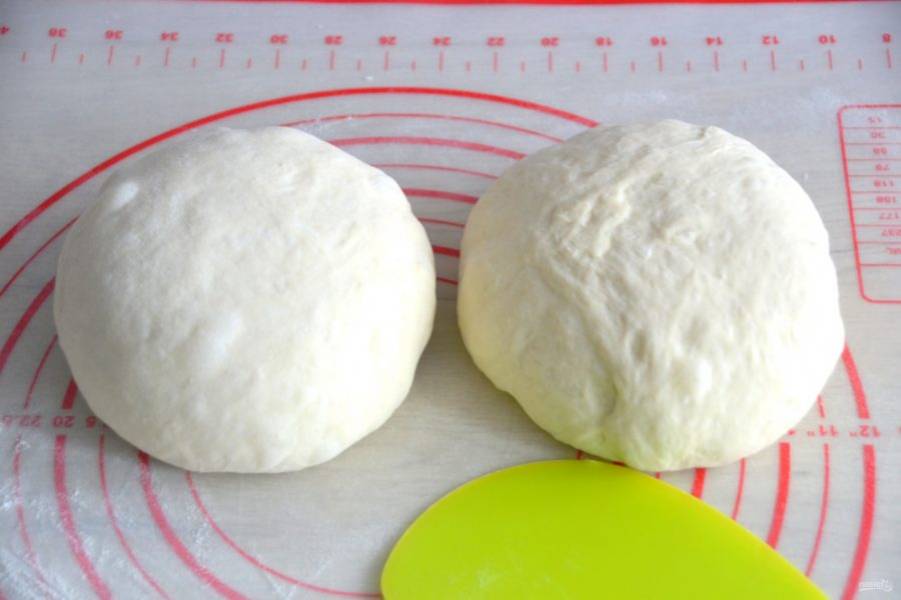 Подошедшее тесто разделите на 2 части, подкатайте их в шар, накройте пищевой пленкой, оставьте на 20-30 минут. 