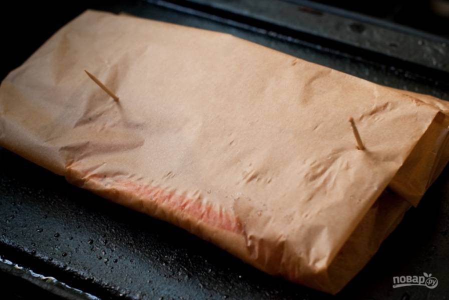 Заверните пергамент конвертиком. Разогрейте духовку до 180 градусов. Отправьте рыбу запекаться минут на 15-20. 
