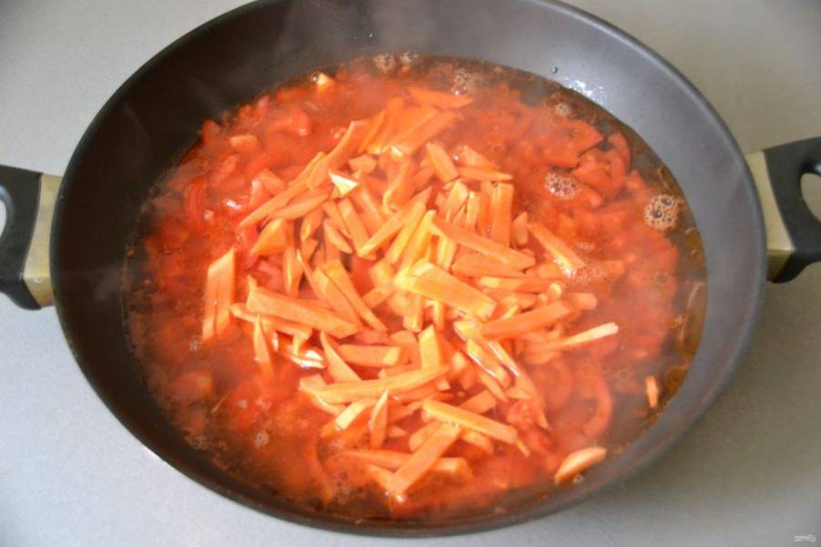 Добавьте в соус порезанную брусочками морковь, залейте двумя стаканами кипятка и тушите минут 5-7.