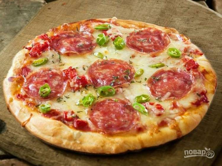Пицца с колбасой, сыром и помидорами на сковороде