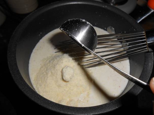 7. Добавить соль, перец и мускатный орех по вкусу. Натертый на мелкой терке пармезан разделить пополам и одну часть всыпать в соус. 